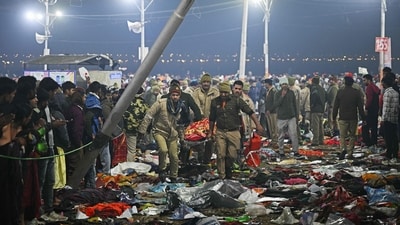 Security personnel carry an injured pilgrim at the site of a stampede amid the ongoing Maha Kumbh Mela festival in Prayagraj. (Arun Sankar/AFP)