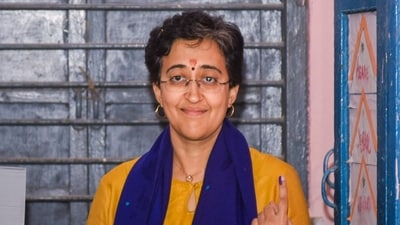 Delhi Chief Minister and AAP leader Atishi displayed her inked finger after casting her vote in the state Assembly elections in New Delhi (PTI) Delhi Chief Minister and AAP leader Atishi displayed her inked finger after casting her vote in the state Assembly elections in New Delhi (PTI)