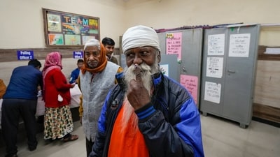 A man displays his inked finger after voting at a polling booth in Trilokpuri, New Delhi, during the Delhi Assembly elections on Wednesday. (PTI) A man displays his inked finger after voting at a polling booth in Trilokpuri, New Delhi, during the Delhi Assembly elections on Wednesday. (PTI)