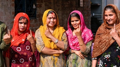 Pakistani Hindu refugees show their inked fingers after casting their votes for the first time in the Delhi Assembly elections at a resettlement colony in Majnu Ka Tila. (PTI) Pakistani Hindu refugees show their inked fingers after casting their votes for the first time in the Delhi Assembly elections at a resettlement colony in Majnu Ka Tila. (PTI)