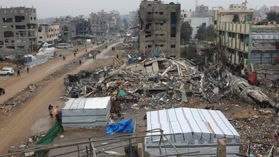 People walk amid collapsed buildings along Saftawi street in Jabalia in the northern Gaza Strip on February 5, 2025 during a ceasefire deal in the war between Israel and Hamas went into effect. (AFP) People walk amid collapsed buildings along Saftawi street in Jabalia in the northern Gaza Strip on February 5, 2025 during a ceasefire deal in the war between Israel and Hamas went into effect. (AFP)