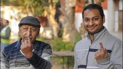 People show their inked fingers after casting their votes at a polling booth in New Delhi on Wednesday. (PTI Photo) People show their inked fingers after casting their votes at a polling booth in New Delhi on Wednesday. (PTI Photo)
