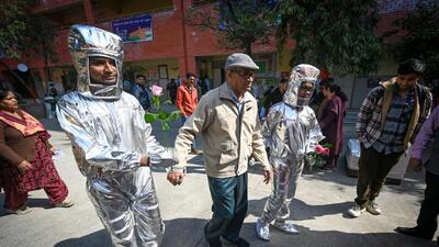 Poll booth volunteers dressed up as astronauts at a polling station in Vikaspuri. (Sanchit Khanna/HT Photo) Poll booth volunteers dressed up as astronauts at a polling station in Vikaspuri. (Sanchit Khanna/HT Photo)