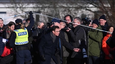 Sweden's Prime Minister Ulf Kristersson (C) passes under the police cordon to return to the site, the adult education center Campus Risbergska school in Orebro, Sweden, on February 5, 2025 one day after a shooting at the adult education center Campus Risbergska school, where eleven people were killed (Photo by Jonathan NACKSTRAND / AFP) (AFP) Sweden's Prime Minister Ulf Kristersson (C) passes under the police cordon to return to the site, the adult education center Campus Risbergska school in Orebro, Sweden, on February 5, 2025 one day after a shooting at the adult education center Campus Risbergska school, where eleven people were killed (Photo by Jonathan NACKSTRAND / AFP) (AFP)