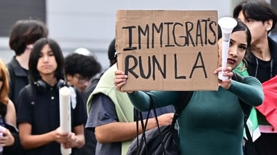 A person holds a sign as hundreds of high school students participate in a protest entitled "A Day Without Immigrants" through downtown Los Angeles on February 4, 2025, against stepped-up federal enforcement against illegal immigration. (AFP) A person holds a sign as hundreds of high school students participate in a protest entitled "A Day Without Immigrants" through downtown Los Angeles on February 4, 2025, against stepped-up federal enforcement against illegal immigration. (AFP)