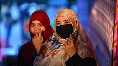 Two women raise their inked fingers after voting in the Delhi assembly elections on Wednesday. (HT Photo/ Sanchit Khanna) Two women raise their inked fingers after voting in the Delhi assembly elections on Wednesday. (HT Photo/ Sanchit Khanna)