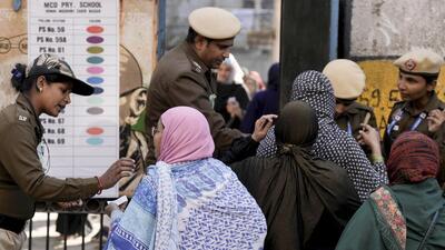 Women arrive to cast their votes during at Jamia Nagar, Okhla, on Wednesday. (PTI) Women arrive to cast their votes during at Jamia Nagar, Okhla, on Wednesday. (PTI)