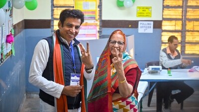 Delhi Congress President Devender Yadav, accompanied by a family member, proudly displays his inked finger after voting at a polling station during the Delhi Assembly elections on Wednesday. (@INCDelhi) Delhi Congress President Devender Yadav, accompanied by a family member, proudly displays his inked finger after voting at a polling station during the Delhi Assembly elections on Wednesday. (@INCDelhi)