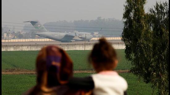 A US Air Force aircraft carrying the Indian migrants deported from the United States landing at the Amritsar airport on Wednesday. (Reuters)