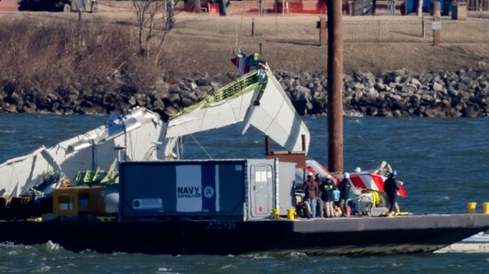 A piece of wreckage is lifted from the water onto a salvage vessel, near the site in the Potomac River of a mid-air collision between an American Airlines jet and a Black Hawk helicopter, at Ronald Reagan Washington National Airport, Tuesday, Feb. 4, 2025, in Arlington, (AP)