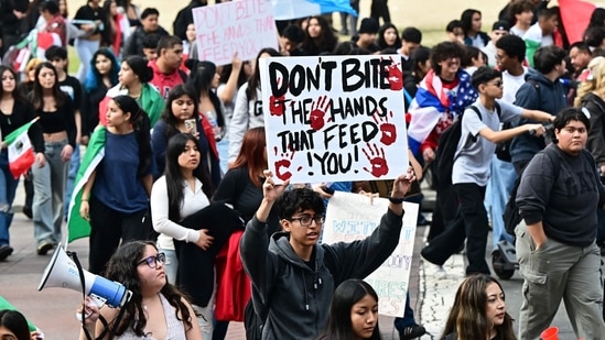 A person holds a sign as hundreds of high school students participate in a protest entitled "A Day Without Immigrants" through downtown Los Angeles on February 4, 2025, against stepped up federal enforcement against illegal immigration. (AFP)