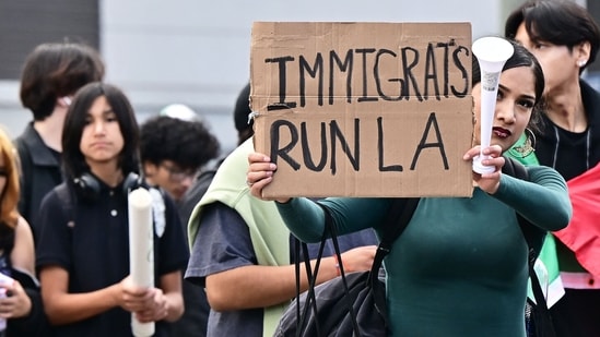 A person holds a sign as hundreds of high school students participate in a protest entitled "A Day Without Immigrants" through downtown Los Angeles on February 4, 2025, against stepped-up federal enforcement against illegal immigration. (AFP)