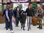 Security personnel escort Gujarat natives deported from US after they were brought to the Ahmedabad airport. Security personnel escort Gujarat natives deported from US after they were brought to the Ahmedabad airport.
