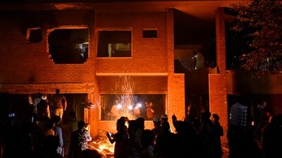 People watch as protesters use heavy machinery to demolish the residence of Sheikh Mujibur Rahman at Dhanmondi, in Dhaka, Bangladesh, early Thursday. (Mahmud Hossain Opu/AP) People watch as protesters use heavy machinery to demolish the residence of Sheikh Mujibur Rahman at Dhanmondi, in Dhaka, Bangladesh, early Thursday. (Mahmud Hossain Opu/AP)