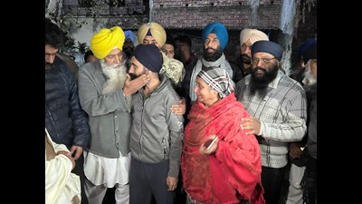 Harwinder Singh of Hoshiarpur's Tahli village meets his family on Wednesday. (Harpreet Kaur/HT)