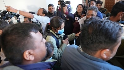 Police officers escort a masked immigrant woman, deported from the United States, who was among those arriving on a US military plane in Amritsar on Wednesday, as she arrives at Ahmedabad Airport in India on Thursday, February 6, 2025. (AP) Police officers escort a masked immigrant woman, deported from the United States, who was among those arriving on a US military plane in Amritsar on Wednesday, as she arrives at Ahmedabad Airport in India on Thursday, February 6, 2025. (AP)