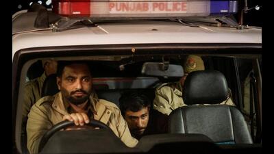 One of the illegal immigrants from Punjab who was deported from the US sits in a police vehicle as they leave the airport in Amritsar on Wednesday. (Reuters) One of the illegal immigrants from Punjab who was deported from the US sits in a police vehicle as they leave the airport in Amritsar on Wednesday. (Reuters)