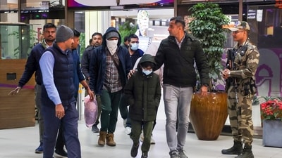 Security personnel escorted Gujarat natives deported from the US after arriving at Ahmedabad Airport on Thursday, February 6, 2025. Among the deportees were 19 women and 13 minors, including a 4-year-old boy and two girls aged 5 and 7. (PTI) Security personnel escorted Gujarat natives deported from the US after arriving at Ahmedabad Airport on Thursday, February 6, 2025. Among the deportees were 19 women and 13 minors, including a 4-year-old boy and two girls aged 5 and 7. (PTI)