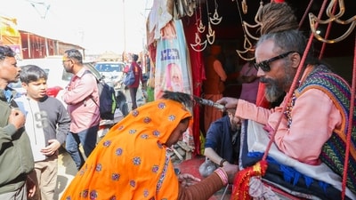 A 'sadhu' blesses a devotee during the ongoing Maha Kumbh Mela 2025, in Prayagraj, Uttar Pradesh, Thursday, Feb. 6, 2025. (PTI) A 'sadhu' blesses a devotee during the ongoing Maha Kumbh Mela 2025, in Prayagraj, Uttar Pradesh, Thursday, Feb. 6, 2025. (PTI)