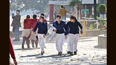 Students caught in dusty winds at Sukhna Lake in Chandigarh on Thursday. (Ravi Kumar/HT)