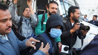 An Indian immigrant deported from the US exits the airport in Ahmedabad, Gujarat, on Thursday. (Reuters)