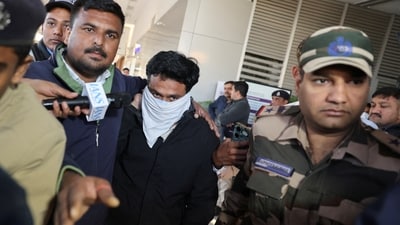 Security personnel escort an Indian immigrant deported from the US as they leave the airport in Ahmedabad. Family members of the deported Gujarat natives claimed they were unaware of how their relatives ended up in the US. (Reuters)