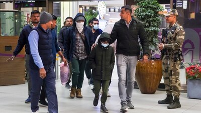 Security personnel escort Gujarat natives deported from US after they were brought to the Ahmedabad airport. (PTI) Security personnel escort Gujarat natives deported from US after they were brought to the Ahmedabad airport. (PTI)