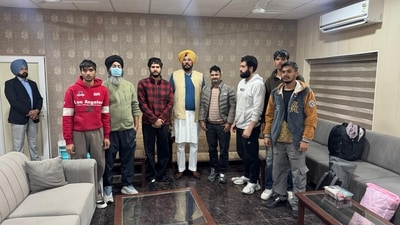 Punjab cabinet minister Kuldeep Singh Dhaliwal met with Swaran Us, a deported youth, at Sri Guru Ram Dass Jee International Airport in Amritsar on Wednesday. (HT Photo) Punjab cabinet minister Kuldeep Singh Dhaliwal met with Swaran Us, a deported youth, at Sri Guru Ram Dass Jee International Airport in Amritsar on Wednesday. (HT Photo)