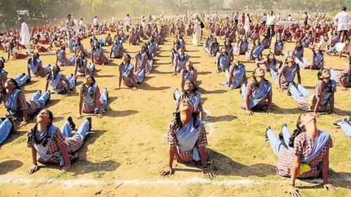 Students performing Surya Namaskar, a form of Yoga, at Mulund Sambhaji ground in Mumbai. (Praful Gangurde/HT File Photo)
