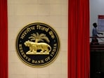 RBI Monetary Policy meeting: A worker walks past the logo of Reserve Bank of India (RBI) inside its office in New Delhi, India.