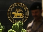 RBI MPC: A police officer walks past the Reserve Bank of India (RBI) logo inside its headquarters in Mumbai, India.