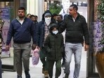 Security personnel escort Indian immigrants deported from the U.S., as they leave the airport in Ahmedabad, India.