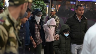 Indian police officials escort immigrants deported from the United States, who were among those who arrived in a US military plane on Wednesday in Amritsar, upon their arrival at the Ahmedabad airport in India, on Thursday, (AP) Indian police officials escort immigrants deported from the United States, who were among those who arrived in a US military plane on Wednesday in Amritsar, upon their arrival at the Ahmedabad airport in India, on Thursday, (AP)