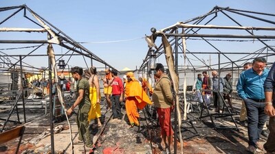 People gather at the site after a fire broke out at a camp during the ongoing Maha Kumbh Mela 2025, in Prayagraj, Uttar Pradesh, Friday. (PTI)