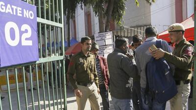 Police conduct security checks at a counting centre on the eve of the Delhi assembly election results on Friday. (PTI) Police conduct security checks at a counting centre on the eve of the Delhi assembly election results on Friday. (PTI)