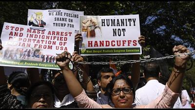 West Bengal Pradesh Congress Committee (WBPCC) activists stage protest with model handcuffs over deportation of 104 Indians from USA to India in alleged handcuffs and shackles. (Samir Jana/HT)