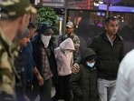 Police officials escort immigrants deported from the United States, who were among those who arrived in a US military plane on Wednesday in Amritsar, upon their arrival at the Ahmedabad airport in India, on Thursday, Police officials escort immigrants deported from the United States, who were among those who arrived in a US military plane on Wednesday in Amritsar, upon their arrival at the Ahmedabad airport in India, on Thursday,