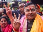 BJP candidate from New Delhi assembly constituency Parvesh Verma shows victory sign upon reaching his residence, amid the counting of votes for the Delhi assembly elections in New Delhi on Saturday, 