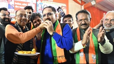 Delhi BJP chief Virendra Sachdeva (in blue shirt) celebrates in New Delhi on Saturday after leading his party to a resounding victory in the Delhi assembly polls. (Hindustan Times) Delhi BJP chief Virendra Sachdeva (in blue shirt) celebrates in New Delhi on Saturday after leading his party to a resounding victory in the Delhi assembly polls. (Hindustan Times)