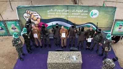 A drone view captures Or Levy, Eli Sharabi, and Ohad Ben Ami, hostages who have been held in Gaza since the October 7, 2023 attack, as they are released by Hamas militants as part of a ceasefire and hostages-prisoners swap deal between Hamas and Israel in Deir Al-Balah, central Gaza Strip, February 8, 2025. (REUTERS)