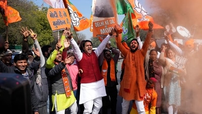 BJP supporters carrying cut outs of Prime Minister Narendra Modi celebrate the Delhi election results on Saturday. (AP) BJP supporters carrying cut outs of Prime Minister Narendra Modi celebrate the Delhi election results on Saturday. (AP)