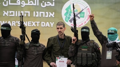 Israeli captive Or Levy, who has been held hostage by Hamas in Gaza since October 7, 2023, is escorted by Hamas fighters before being handed over to the Red Cross in Deir al-Balah, central Gaza Strip, on Saturday. (AP) Israeli captive Or Levy, who has been held hostage by Hamas in Gaza since October 7, 2023, is escorted by Hamas fighters before being handed over to the Red Cross in Deir al-Balah, central Gaza Strip, on Saturday. (AP)