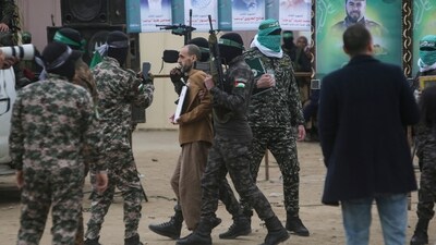 Israeli captive Eli Sharabi, held hostage by Hamas in Gaza since October 7, 2023, is escorted by Hamas fighters before being handed over to the Red Cross in Deir al-Balah, central Gaza Strip, on Saturday, February 8, 2025. (AP) Israeli captive Eli Sharabi, held hostage by Hamas in Gaza since October 7, 2023, is escorted by Hamas fighters before being handed over to the Red Cross in Deir al-Balah, central Gaza Strip, on Saturday, February 8, 2025. (AP)