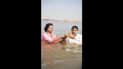 MP chief minister Mohan Yadav, along with his family, taking a dip in the sacred Sangam on Saturday. (HT )