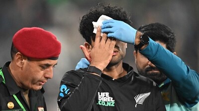 New Zealand's Rachin Ravindra (C) receives medical attention after being hit on the head by the ball during the Tri-Nation's first one-day international cricket match between Pakistan and New Zealand at the Gaddafi Stadium in Lahore. (AFP) New Zealand's Rachin Ravindra (C) receives medical attention after being hit on the head by the ball during the Tri-Nation's first one-day international cricket match between Pakistan and New Zealand at the Gaddafi Stadium in Lahore. (AFP)