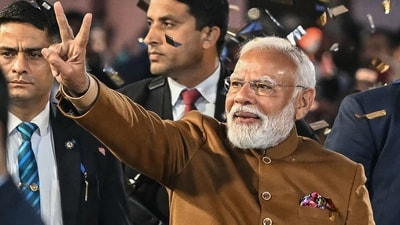 Prime Minister Narendra Modi flashes victory sign as he arrives at the Bharatiya Janata Party (BJP) headquarters to celebrate the party's win in the Delhi legislative assembly election. (AFP)