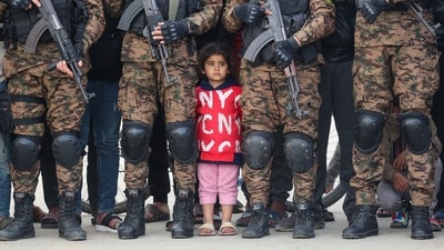 A Palestinian girl watches the handover of three Israeli hostages to a Red Cross team in Deir el-Balah, central Gaza, on February 8, 2025. Hamas militants released three Israeli hostages as part of the fifth exchange under a fragile Gaza ceasefire, with 183 prisoners held by Israel scheduled for release later in the day. (AFP) A Palestinian girl watches the handover of three Israeli hostages to a Red Cross team in Deir el-Balah, central Gaza, on February 8, 2025. Hamas militants released three Israeli hostages as part of the fifth exchange under a fragile Gaza ceasefire, with 183 prisoners held by Israel scheduled for release later in the day. (AFP)