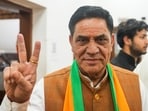 Newly elected MLA Mohan Singh Bisht flashes victory sign before a meeting after the victory in Delhi Assembly elections, at the Delhi state office in New Delhi, Sunday.