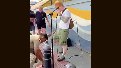 A cop unplugs Sheeran’s microphone on Sunday. (HT Photo) A cop unplugs Sheeran’s microphone on Sunday. (HT Photo)