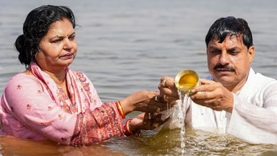 Madhya Pradesh Chief Minister Mohan Yadav with wife Seema Yadav performs rituals while taking a holy dip during Mahakumbh, at Sangam in Prayagraj. (PTI) Madhya Pradesh Chief Minister Mohan Yadav with wife Seema Yadav performs rituals while taking a holy dip during Mahakumbh, at Sangam in Prayagraj. (PTI)